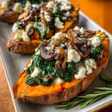 Two slices of roasted sweet potato with mushrooms and cheese.