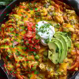A dish of food with a white dollop on top.