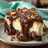 A slice of cake with chocolate drizzled on top.