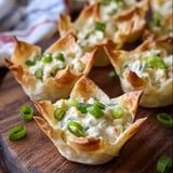 A plate of food with a green vegetable on top.