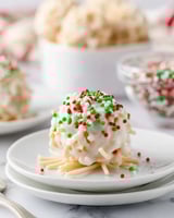 A plate with a white and green candy on it.