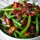 A bowl of bacon and green beans.